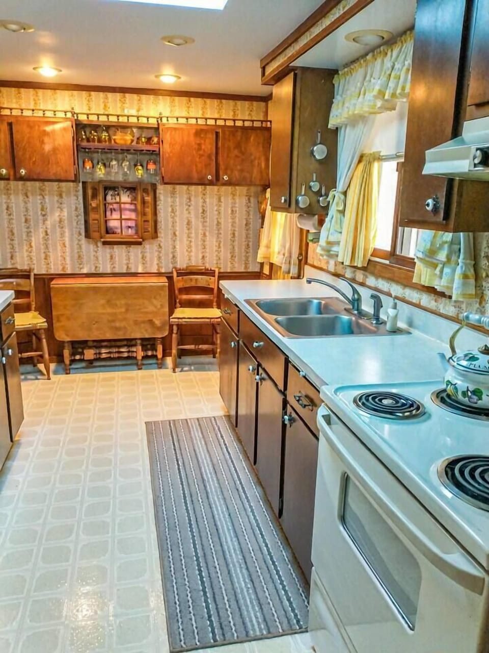 Fully stocked kitchen with additional small table and chairs.