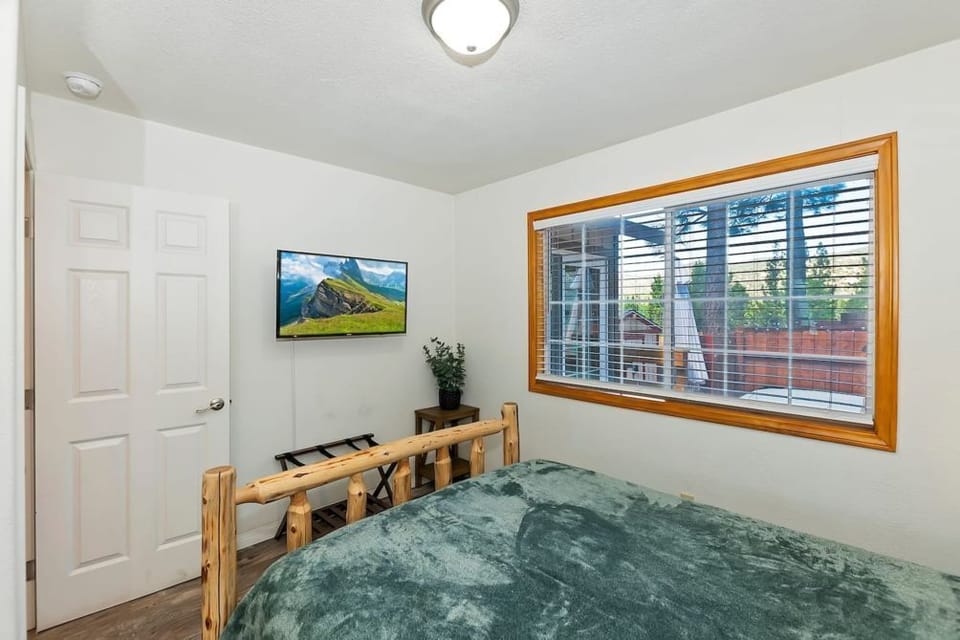 Step into a blend of rustic charm and modern elegance in our inviting cabin-style bedroom.