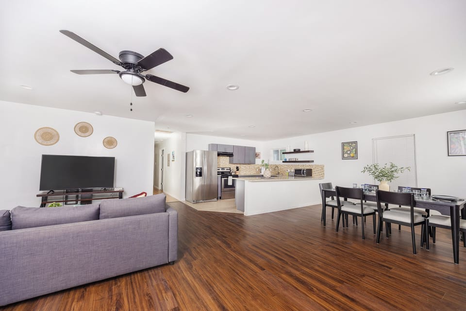 Bright open living area with modern kitchen, perfect for relaxing together.