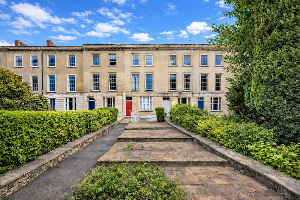 The elegant Georgian façade of our 1841 Clifton townhouse, tucked away in a quiet green setting just steps from the cafés, restaurants, and cinema of Whiteladies Road.