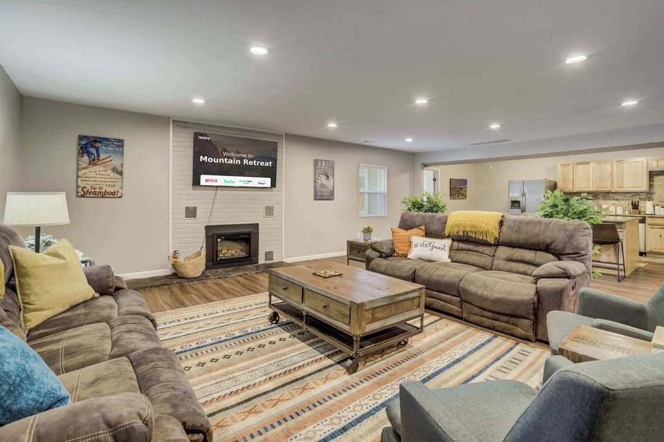 Gather in the inviting living room, where plush reclining sofas, a warm fireplace, and a Smart TV create the perfect space to relax after a day of mountain adventures.





