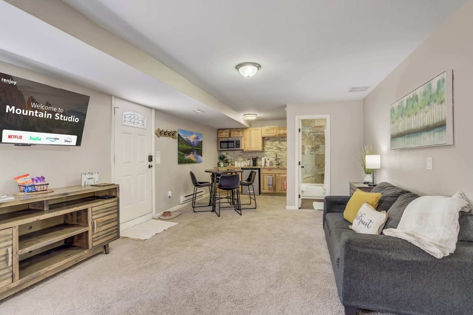 An inviting living space with everything you need – unwind on the comfortable sofa, enjoy your favorite shows on the Smart TV, or gather around the dining area. The open layout seamlessly connects to the kitchenette for added convenience.





