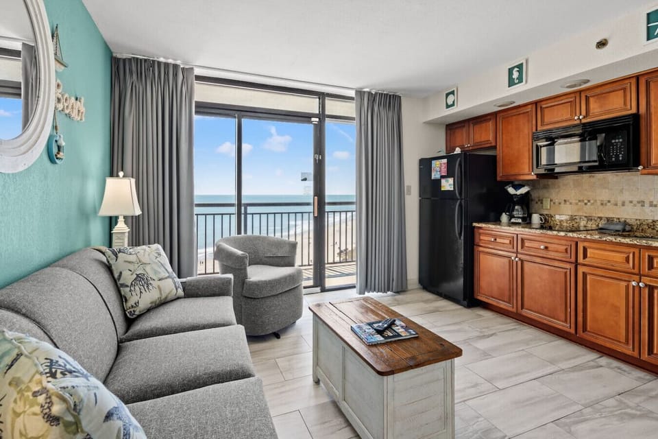 Fully equipped kitchen with full refrigerator, stovetop burners, microwave, coffee maker, toaster, and sink. Includes dinnerware, silverware, and cookware; perfect for preparing meals during your Myrtle Beach stay.