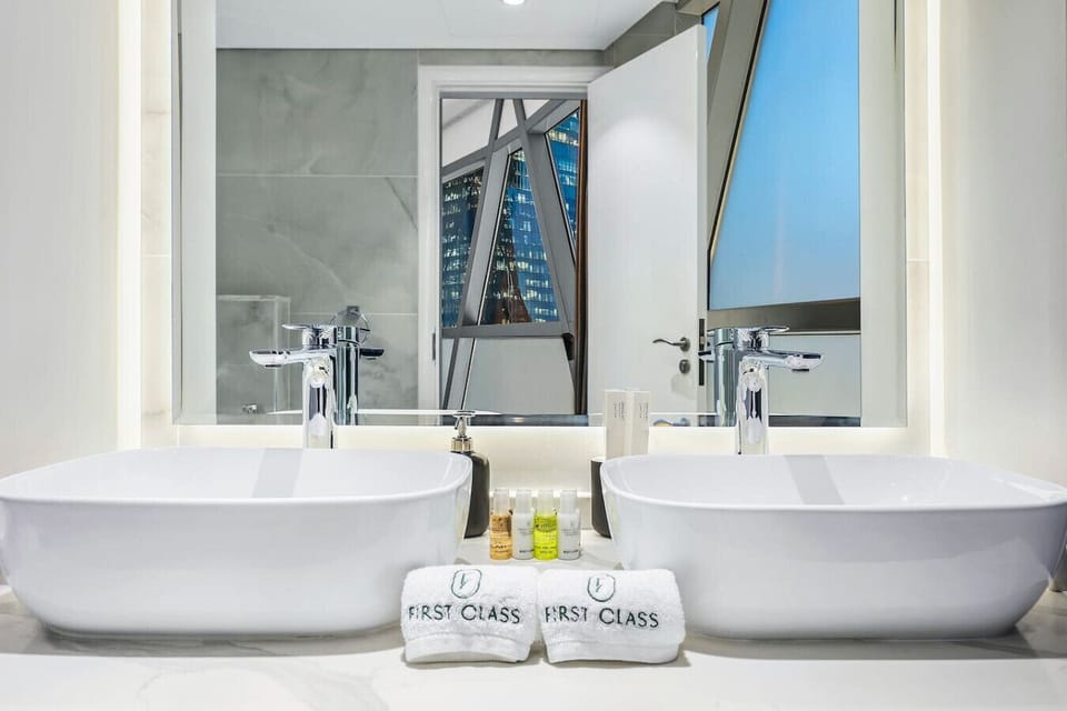 Luxurious Bathroom: Dual sinks and stunning city views create a spa-like retreat!