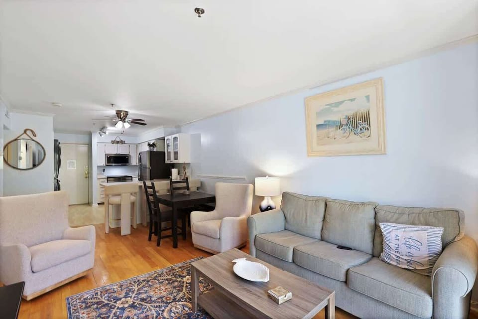 The bright and airy living area features comfortable seating and coastal-inspired decor.