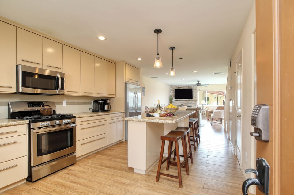 The chef’s kitchen features high-end appliances, a long prep island with bar seating, and dining for six, perfect for entertaining or family meals.