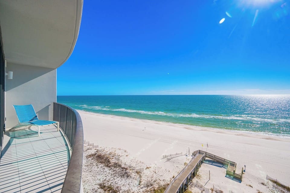 Gentle waves lap the coast as you relax on your balcony chair watching the horizon stretch endlessly
