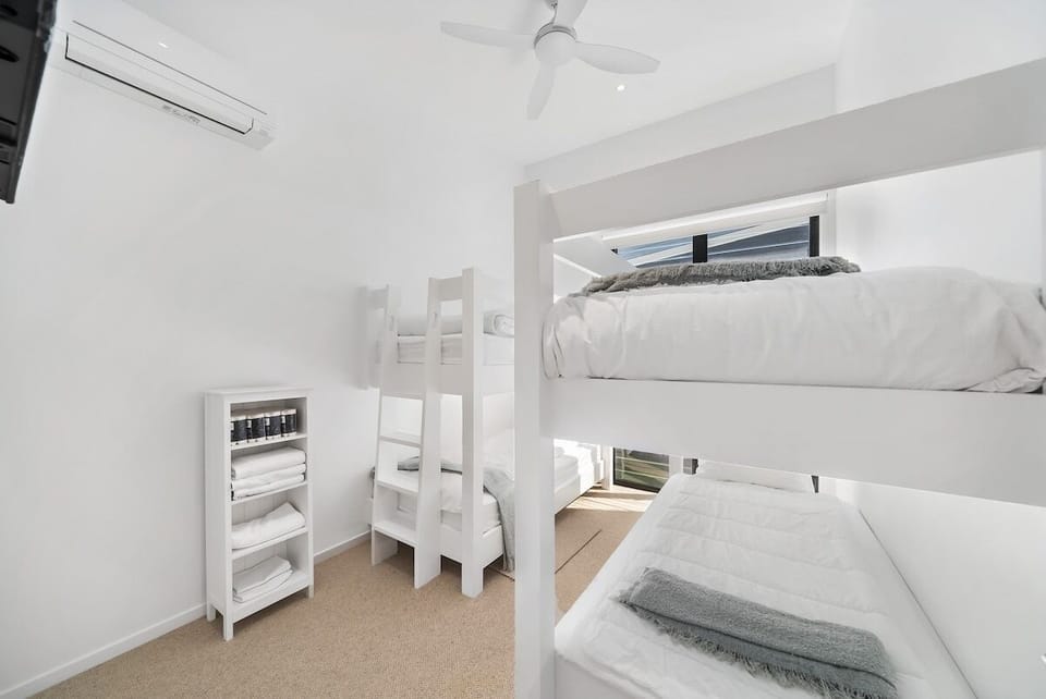 Bedroom 4 has 4 custom-made single bunk beds with extra head height.