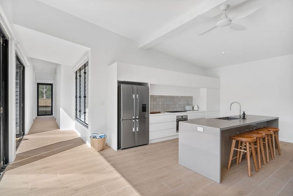 Kitchen with a large island, bar stools, and plenty of natural light.