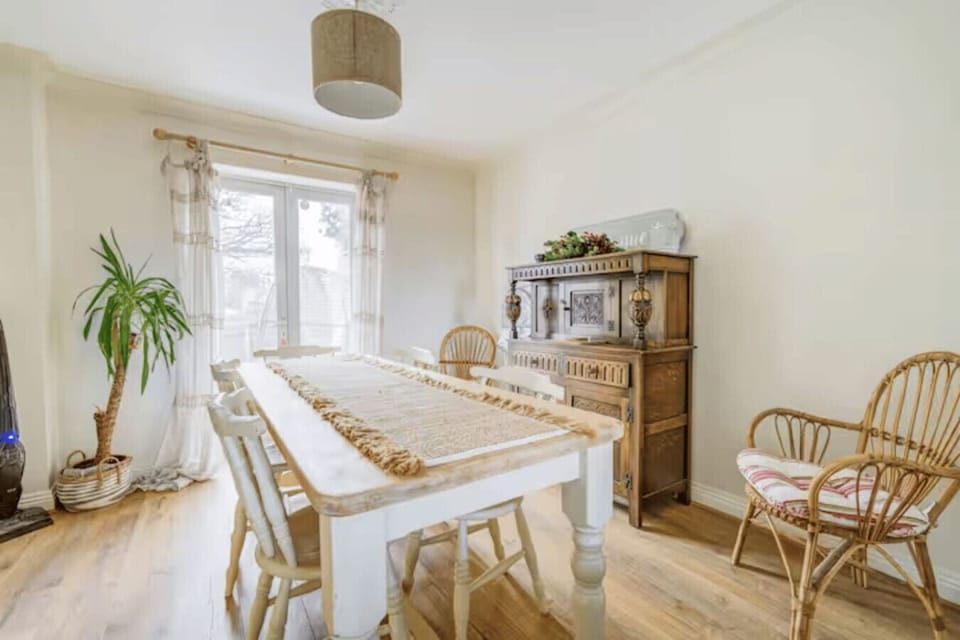 A rustic farmhouse table bathed in natural light invites long, leisurely group meals.