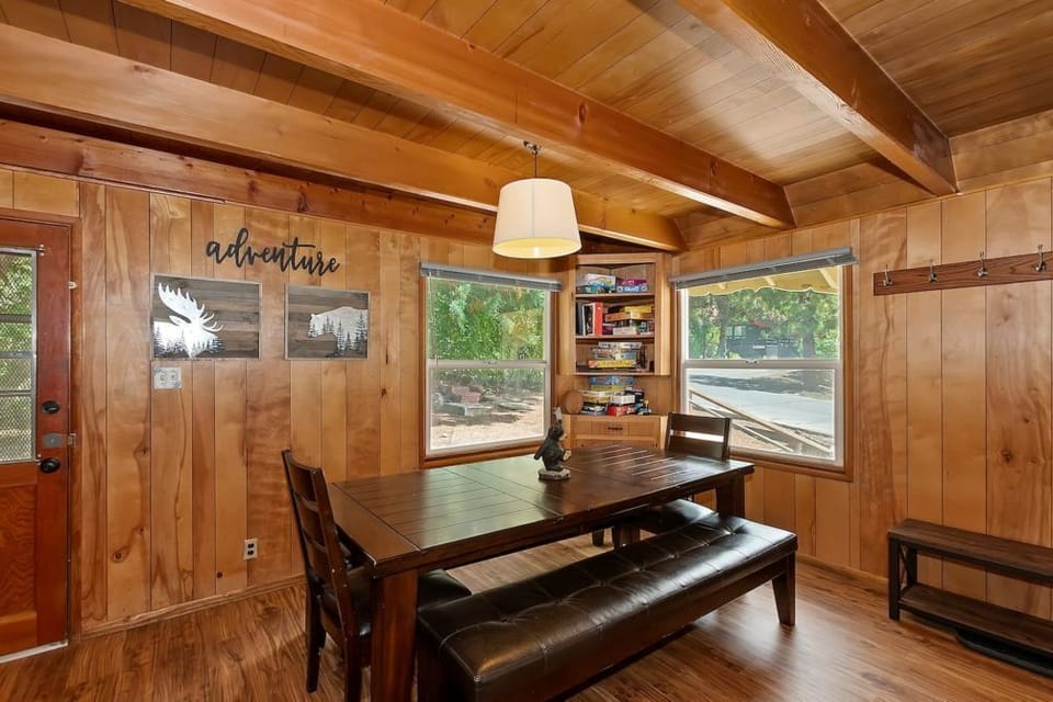 "Experience the rustic charm of our dining area, where wooden beams and a cozy ambiance set the perfect scene for family dinners and board game nights