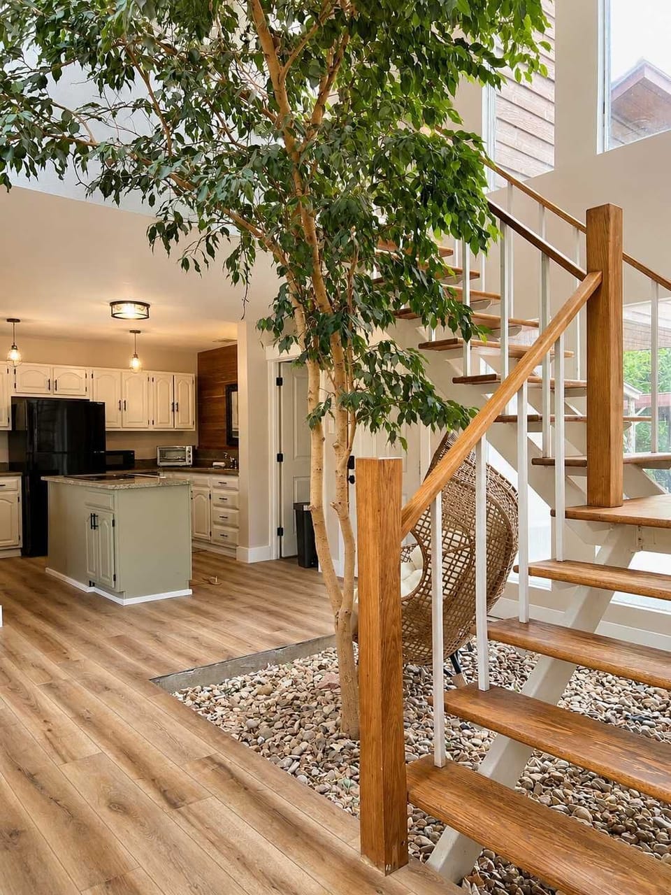This live ficus tree is towering to the ceiling, with a staircase wrapped around it. A comfortable chill space at the base, you can stop and unwind for a bit.