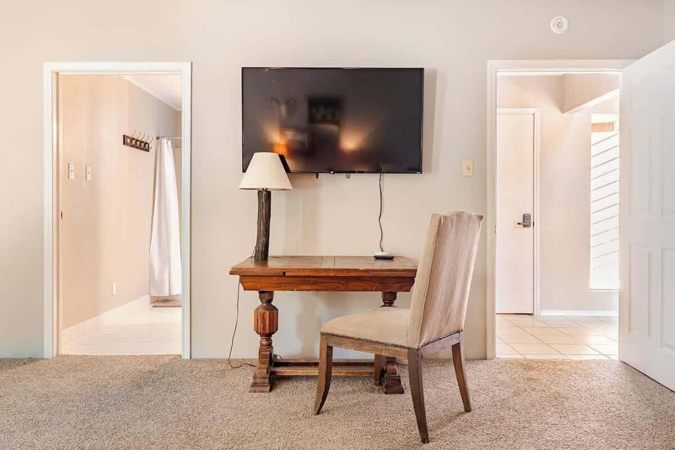 This downstairs bedroom has easy access to everything. The bathroom has a soaking tub and a full bathroom with a smart TV.