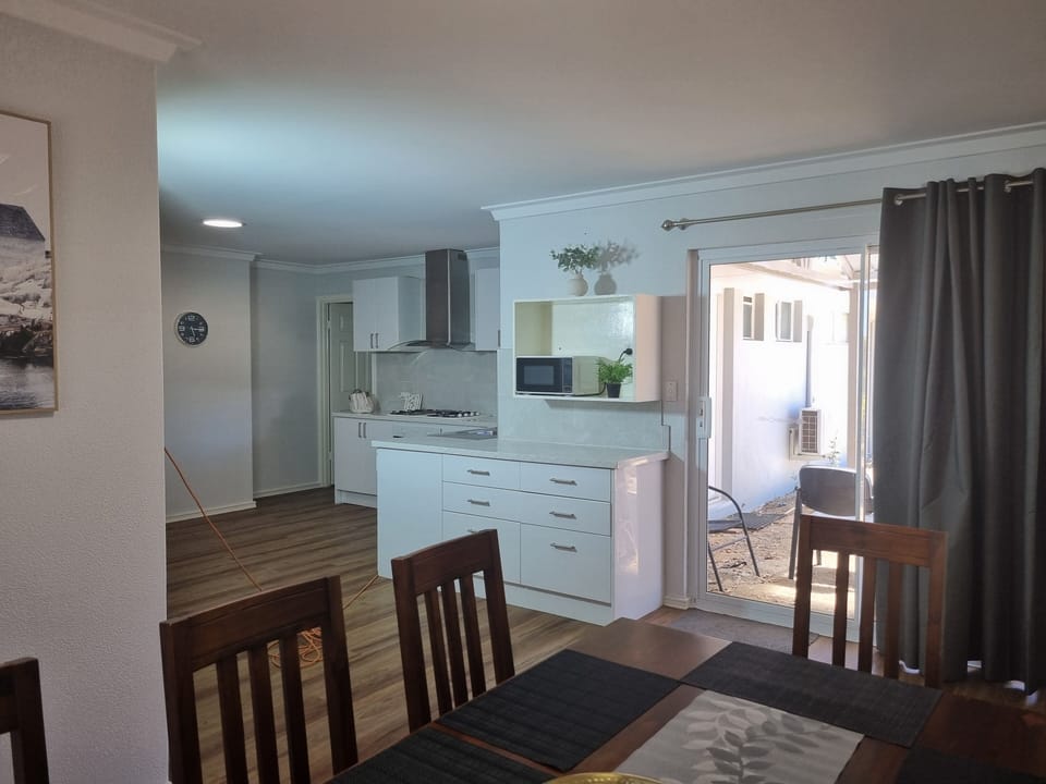 You have easy access from the kitchen to the dining table.