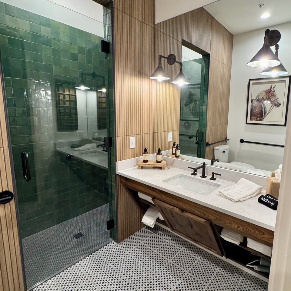 A closer look at the Homestead Suite ADA bathroom — accessible vanity, roll-in shower, and modern Western finishes built for full accessibility.