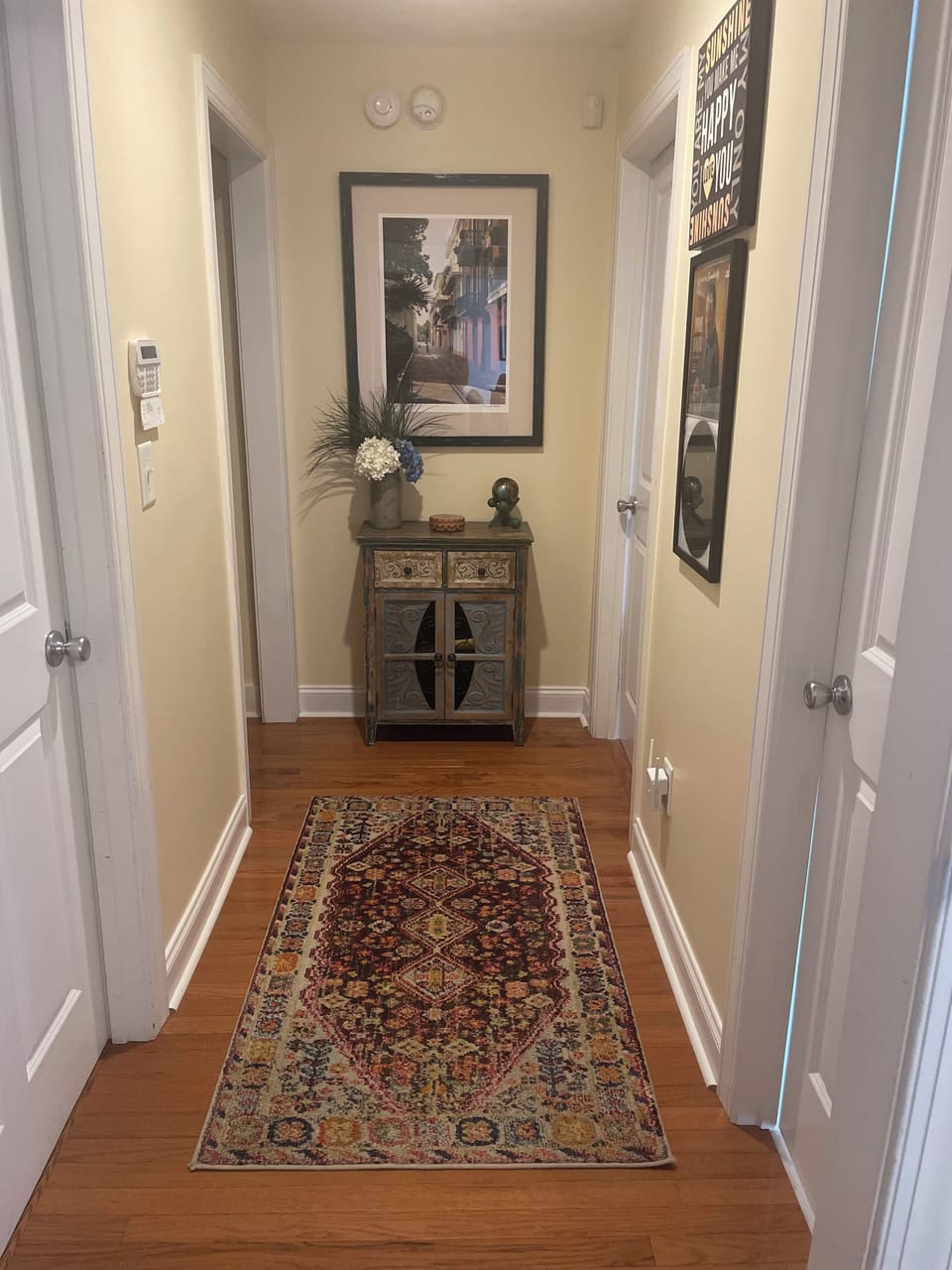 Hallway from kitchen leading to master and upstairs bedrooms, 1/2 bath