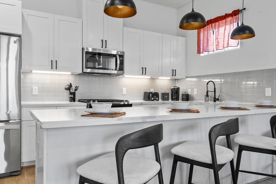 Our kitchen island features plush seats, offering both comfort and style for your casual dining or morning coffee moments.