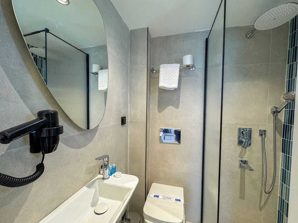 Standard Double Room, Balcony, City View | Bathroom | Shower, hair dryer, slippers, towels