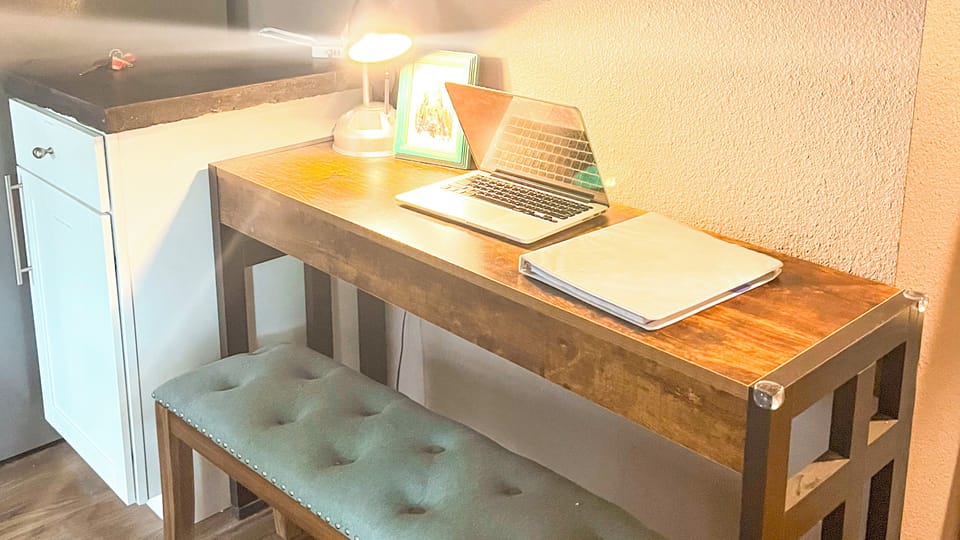 Well-lit desk in kitchen with easy outlet access - ready for remote work! 