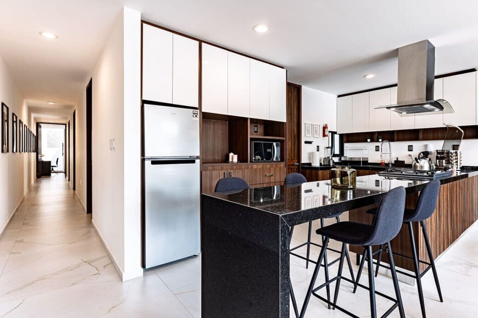 Sleek modern kitchen with island seating, ideal for casual dining or morning coffee