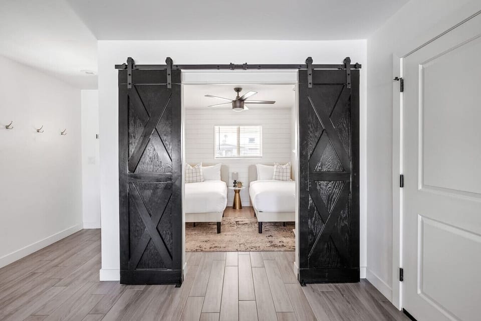Charming fourth bedroom with two twin beds and convenient storage, offering a comfortable and flexible sleeping option.