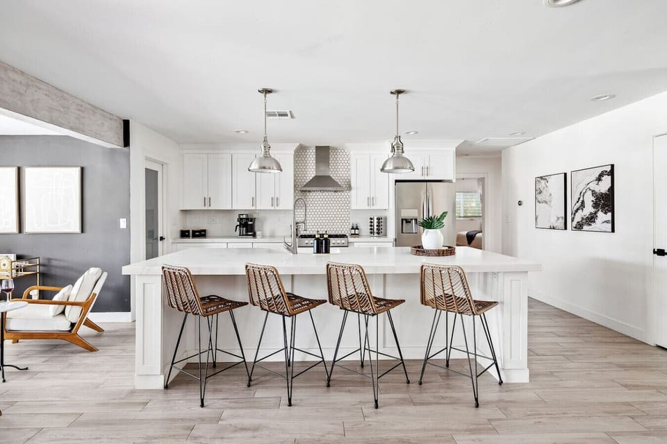 Super spacious, modern kitchen featuring an oversized island and fully stocked with premium essentials, including cookware, blender, wine glasses, toaster, coffee maker, spices, and more.