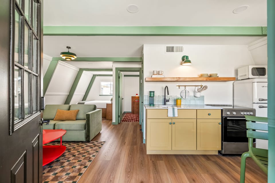 Premium Suite, Pool View | Living area | 27-inch TV with cable channels