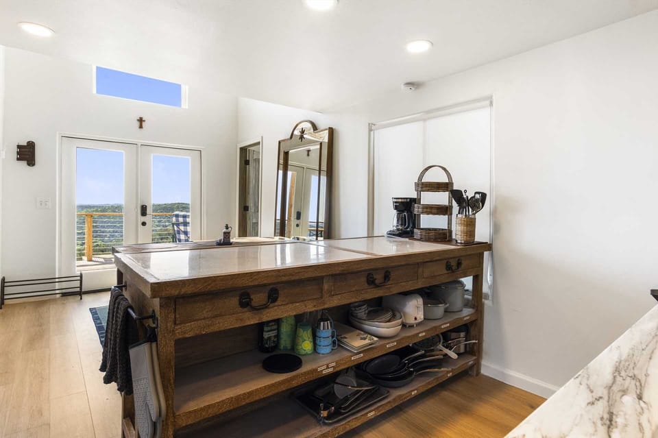 Bright, open kitchen with organized island storage and scenic views-ideal for morning coffee or evening meals.