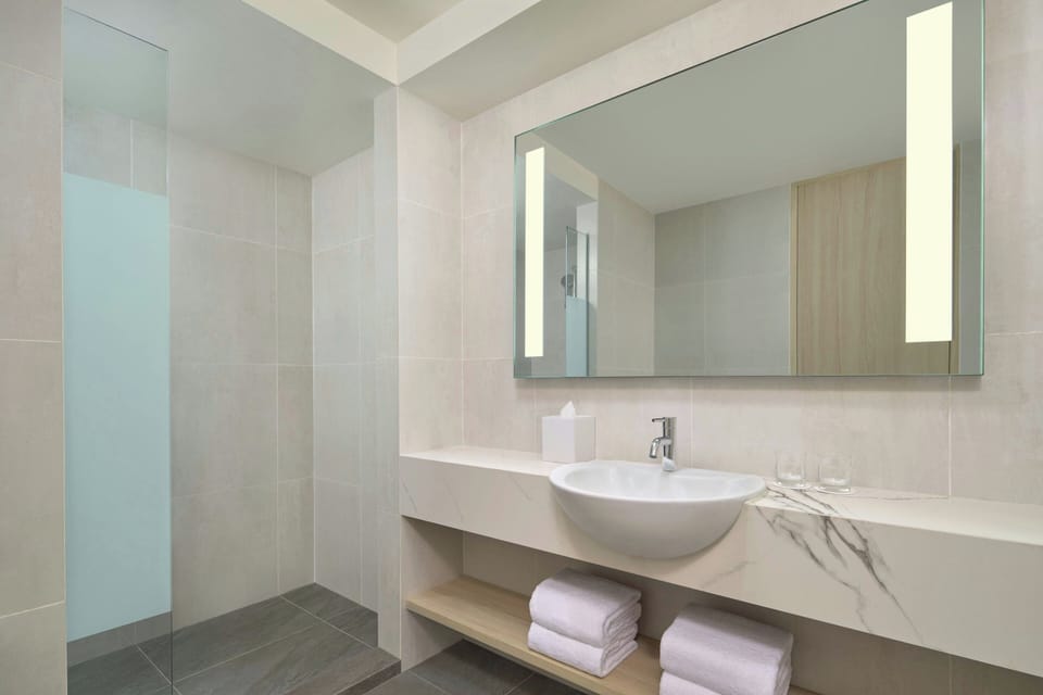 Shower, hair dryer, slippers, towels