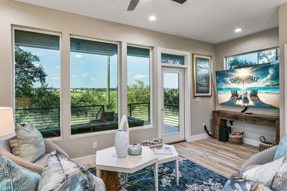 Living room leads to covered waterside patio