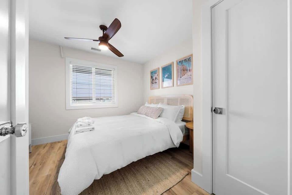 Spacious guest bedroom with comfortable queen bed.