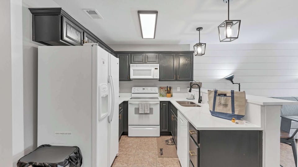 Whip up your favorite meals in this bright, fully stocked kitchen — there’s plenty of space to cook, chat, and make memories together.
