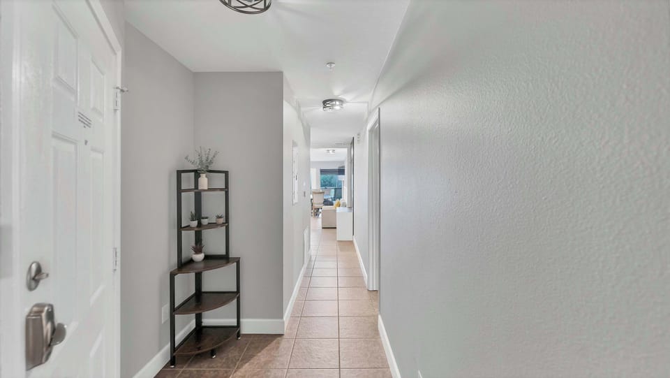 The entry hallway, styled with plants and natural touches, makes a bright and welcoming first impression.