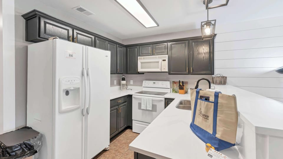 The fully equipped kitchen provides generous cabinet and counter space — perfect for preparing meals together.