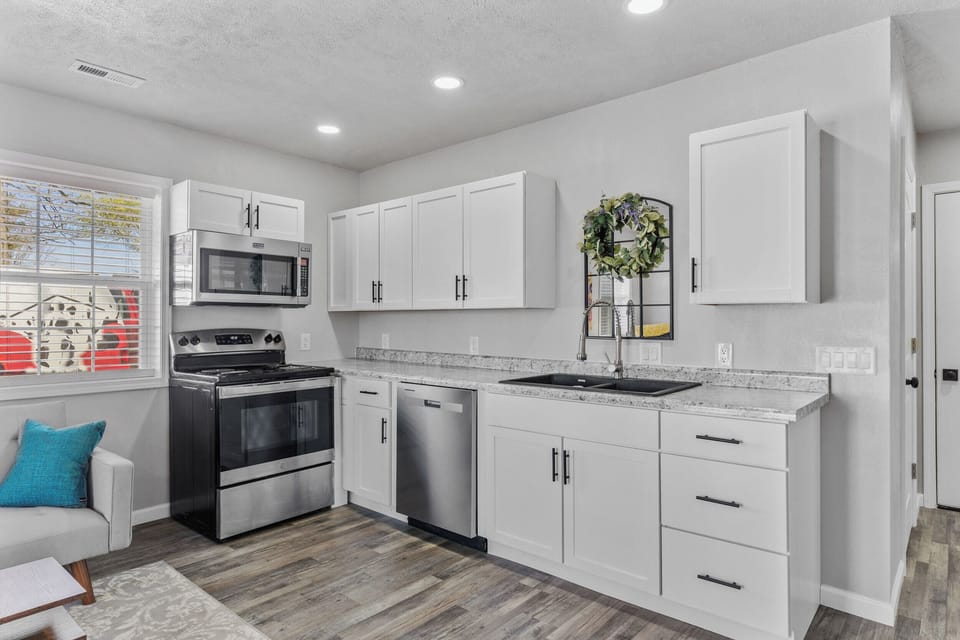 Full kitchen with refrigerator, microwave, dishwasher, stove/oven, coffee maker
