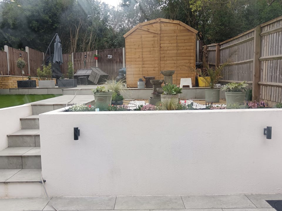 The rear of the property offers a beautiful view of a mediterranean style garden with a relaxing water feature.