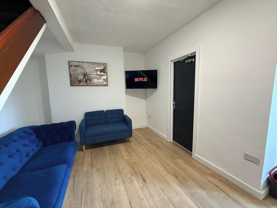 Relax in a spacious living room with comfortable seating. Enjoy your time on a large TV. Perfect for unwinding or spending time with friends and family.