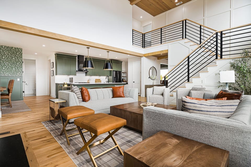 Open the doors off the living room straight onto the deck — the indoor-outdoor flow that makes your big group feel easy, with fresh air and the view all at once.