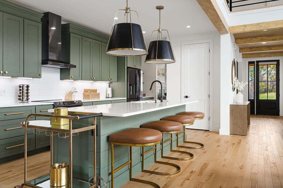Set out a spread on the island while the dining table fills behind you — the heart of the house when twelve people are hungry at the same time.