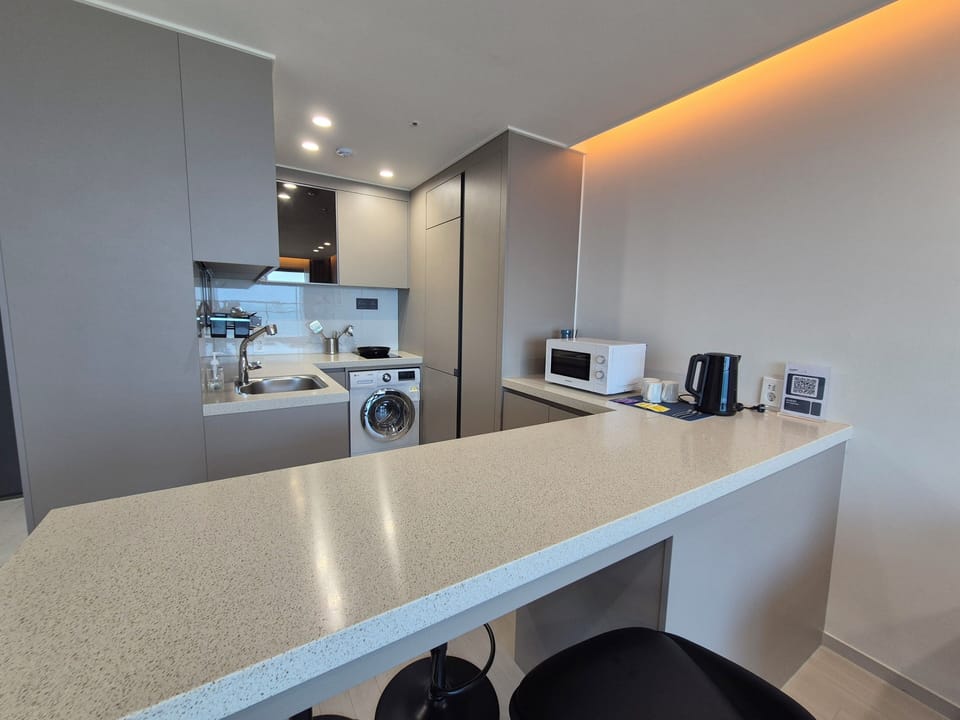Marina Grand Suite | Private kitchen | Fridge, electric kettle, freezer, dining table
