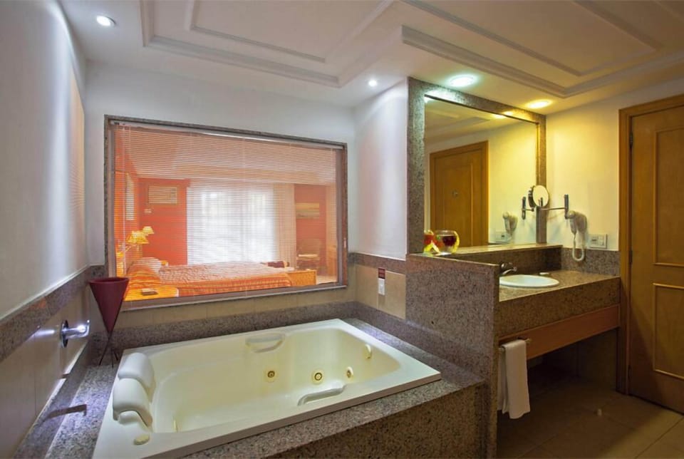 Executive Suite, Pool View (Triple) | Bathroom | Shower, hair dryer, towels