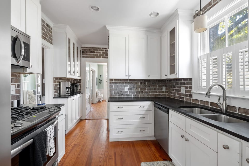 Enjoy plenty of counter space, a deep double basin sink, and natural light streaming through the large windows in this fully stocked kitchen.