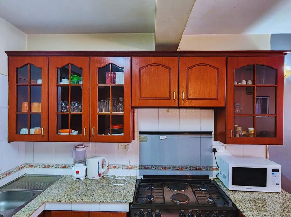 Kitchen with cooker, microwave , kettle and blender