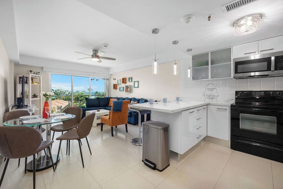 Unwind in the open-concept living, dining, and kitchen with direct access to your private balcony overlooking the pool—perfect for Aruba sunset views.