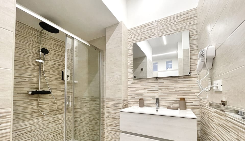Double Room | Bathroom | Shower, hair dryer, bidet, towels