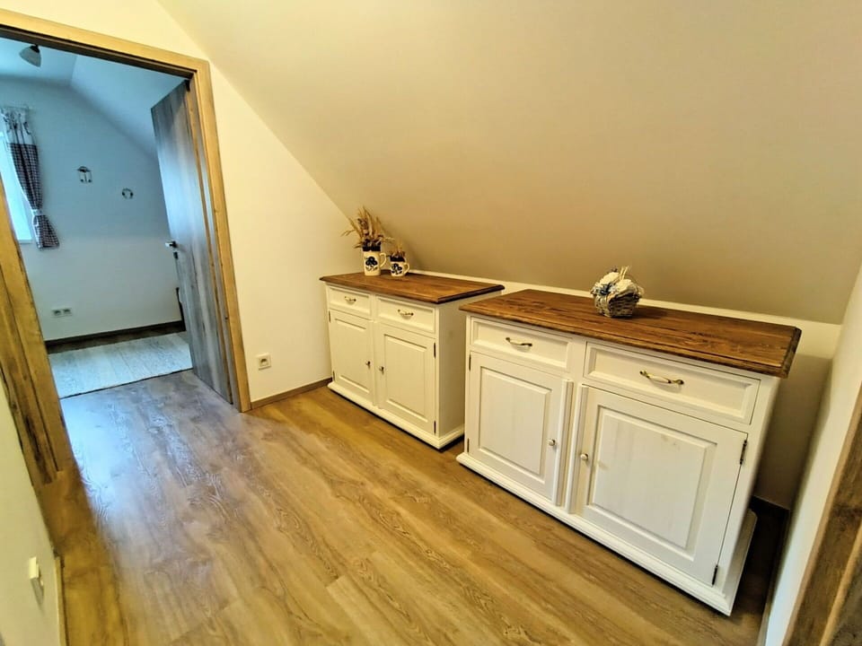 Wood, Flooring, Floor, Wood Flooring, Interior Design, Cabinetry, Wood Stain, Room, Drawer, Laminate Flooring