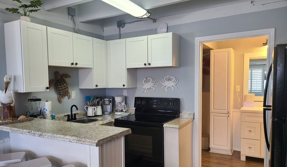 Kitchen Area With Full-Size Fridge and Cookware