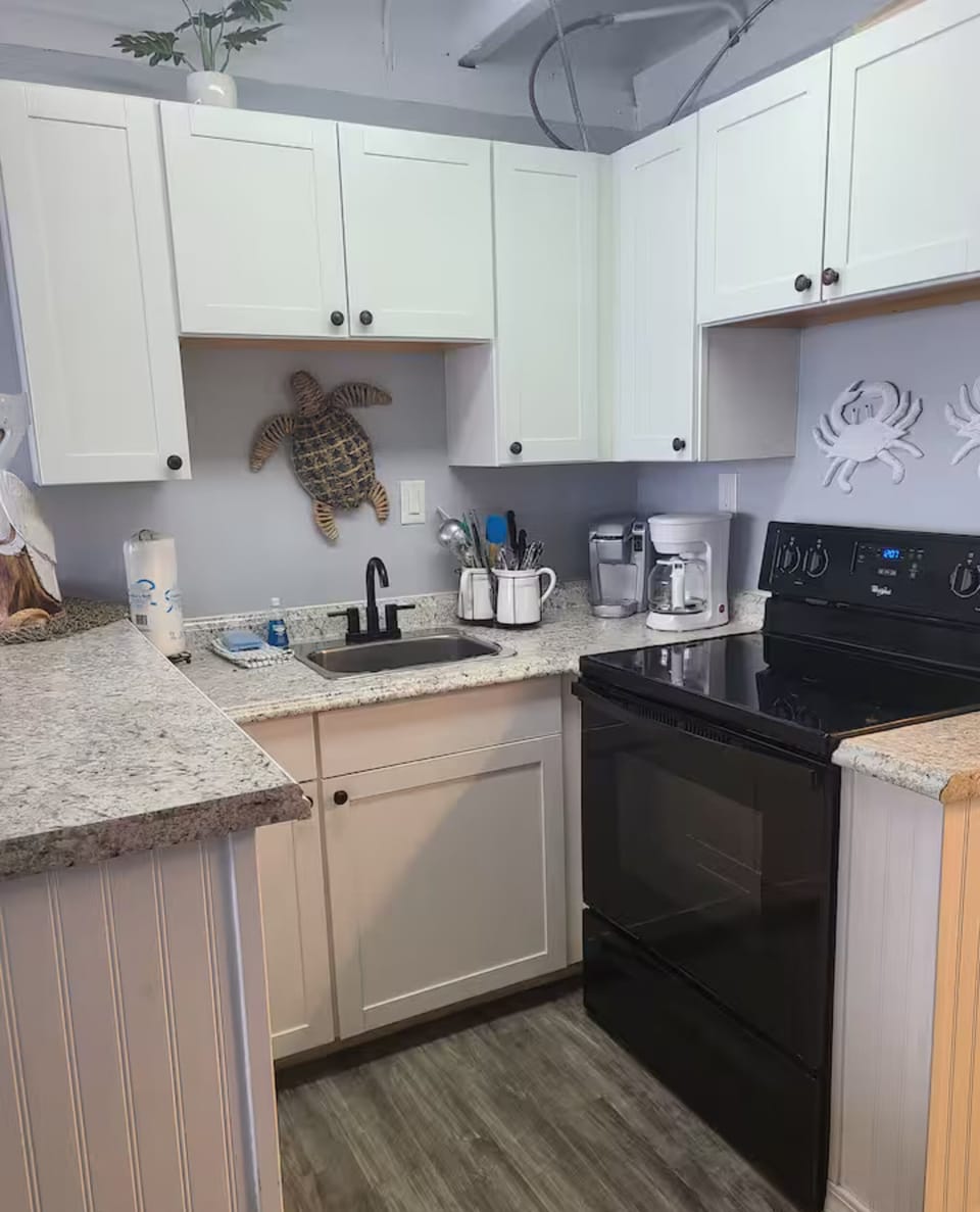 Kitchen with stove, microwave, and cabinetry