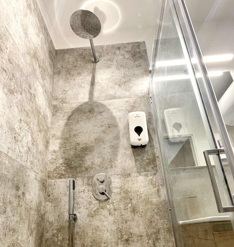 Double Room | Bathroom | Shower, hair dryer, bidet, towels