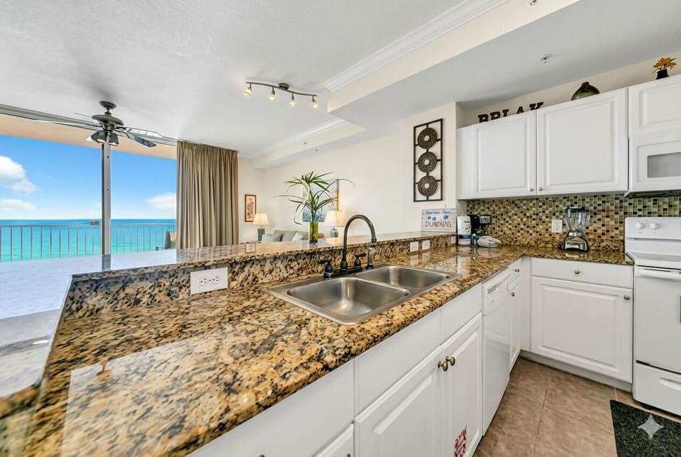 Cook with a WOW view! Fully equipped kitchen with a breakfast bar and stools.